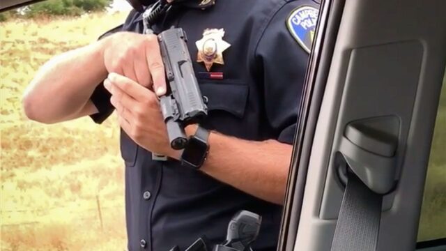 В Калифорнии полицейский девять минут держал под прицелом пассажира машины. Их спор сняли на видео